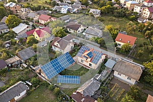 Aerial top view of new modern residential house cottage with blue shiny solar photo voltaic panels system on roof. Renewable