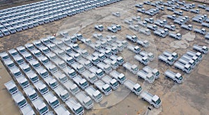 Aerial top view of new truck cars parking for sale stock lot row, dealer inventory import and export business commercial,