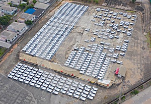 Aerial top view of new truck cars parking for sale stock lot row, dealer inventory import and export business commercial,