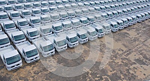 Aerial top view of new truck cars parking for sale stock lot row, dealer inventory import and export business commercial,