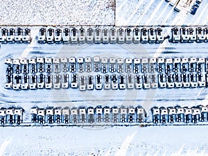 Aerial top view of new truck cars parking for sale stock lot row, dealer inventory import and export business commercial, Automobi
