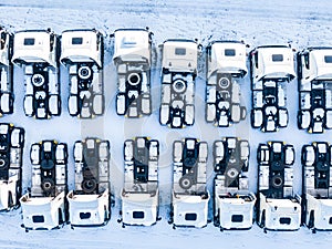 Aerial top view of new truck cars parking for sale stock lot row, dealer inventory import and export business commercial, Automobi