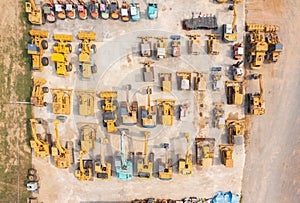 Aerial top view of new truck tractor cars parking for sale stock lot row, dealer inventory import and export business commercial,