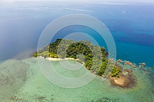 Aerial top view of ocean waves, beach and rocky coastline and beautiful forest. Beautiful nature background. island background and