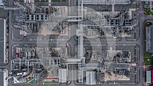 Aerial top view Oil and Gas refinery petrochemical plant industrial with oil and gas storage tank. White oil and gas refinery