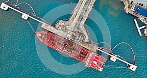 Aerial top view of oil tanker ship at the port, Oil terminal is industrial facility for storage of oil