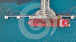Aerial top view of oil tanker ship at the port, Oil terminal is industrial facility for storage of oil