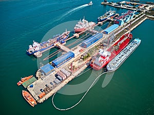 Aerial top view of oil tanker ships at the port, Oil terminal is industrial facility for storage of oil and petrochemical