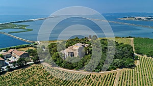 Aerial top view of old church on island from above, canal du Rhone a Sete, Camargue, France