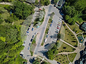 Aerial top view. Open-air car parking lot near a park or forest