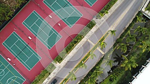 Aerial Top View over playground with tennis, basketball and volleyball court in tropical resort