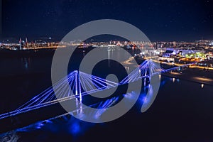 Aerial top view panorema city Krasnoyarsk bridge through Yenisei river evening with neon light