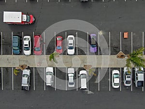 Aerial top view of parking with varieties of colored vehicles