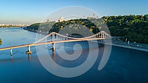 Aerial top view of pedestrian Park bridge and Dnieper river from above, city of Kiev