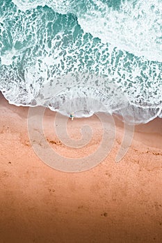 Aerial top view of person surfing in the sea waves in Florida