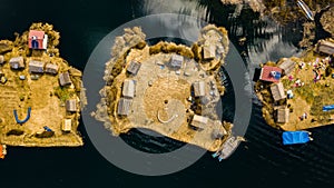 Aerial top view photo of floating islands on Lake Titicaca in Peru