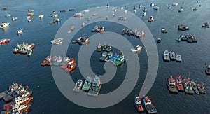 Aerial top view photo of red traditional wooden fishing boat in the harbor