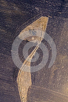 Aerial top view of plowed field and meadow