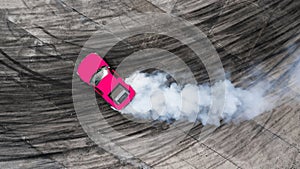 Aerial top view professional driver drifting car on asphalt road track with white smoke, Automobile race car drift on abstract