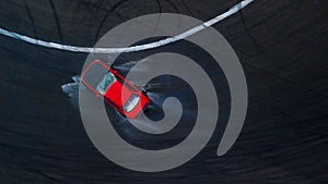 Aerial top view professional driver drifting car on wet race track, with water splash, red car. photo