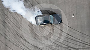 Aerial top view race car drifting on speed track, Professional driver drifting car on race track with smoke, Black tire tracks