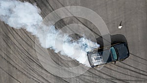 Aerial top view race car drifting on speed track, Professional driver drifting car on race track with smoke, Black tire tracks