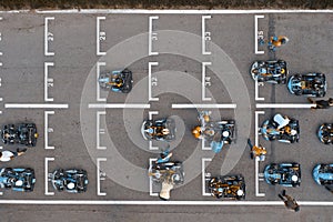 Aerial top view of racing go-kart track with road markings and karts preparing for competition on race starting line