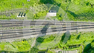 Aerial top view railroad tracks rails and sleepers, several tracks and semaphores