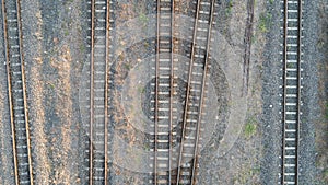 Aerial top view of railroad tracks with some weeds.