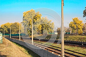 Aerial top view on railway road between trees. Forest landscape background with steel rails. power transmission lines support