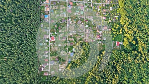 Aerial top view of residential area summer houses in forest from above, countryside real estate and dacha village in Ukraine photo