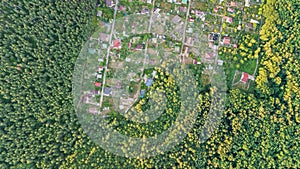 Aerial top view of residential area summer houses in forest from above, countryside real estate and small dacha village in Ukraine