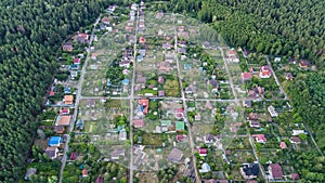 Aerial top view of residential area summer houses in forest from above, countryside real estate and small dacha village in Ukraine