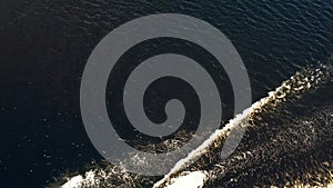 Aerial top view of riding on a watercraft. Boat on the surface of the river. 4K video.