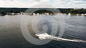 Aerial top view of riding on a watercraft. Boat on the surface of the river. 4K video.