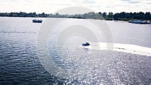 Aerial top view of riding on a watercraft. Boat on the surface of the river. 4K video.