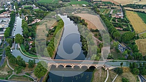 Aerial top view of river, canal du Midi and bridges from above, Beziers town in South France