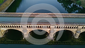 Aerial top view of river, canal du Midi and bridges from above, Beziers town in South France