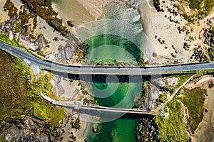 Aerial top view of a road connecting the coasts on a sunny day in Donegal