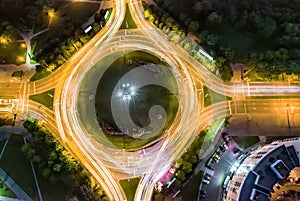 Aerial top view of roundabout with car light trails at night. motion blur