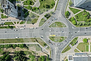Aerial top view of roundabout with cars traffic in city at summer afternoon