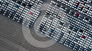 Aerial top view rows of new cars parked in distribution center on car factory, Automobile and automotive car parking lot for