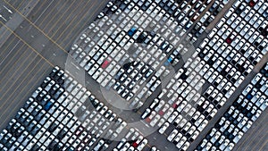 Aerial top view rows of new cars parked in distribution center on car factory, Automobile and automotive car parking lot for