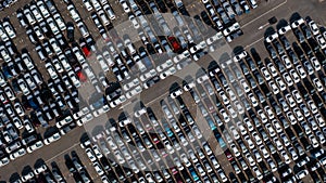 Aerial top view rows of new cars parked in distribution center on car factory, Automobile and automotive car parking lot for