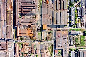 Aerial top view of rusty roofs of industrial buildings and warehouses