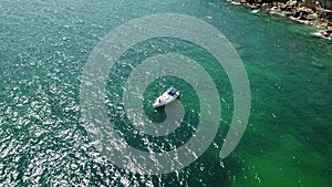 Aerial Top View of a sailboat in blue water
