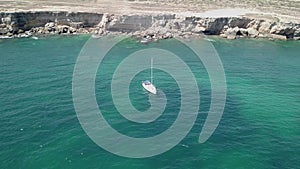 Aerial Top View of a sailboat in blue water