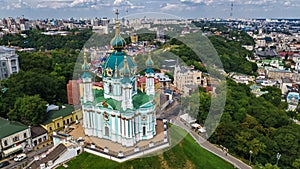 Aerial top view of Saint Andrew`s church and Andreevska street from above, cityscape of Podol district, city of Kiev, Ukrai photo