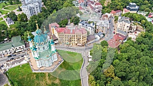Aerial top view of Saint Andrew`s church and Andreevska street from above, cityscape of Podol district, city of Kiev, Ukrai photo