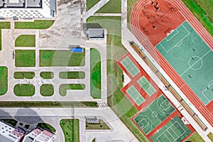 Aerial top view of school courtyard with new sports grounds for team games of sport